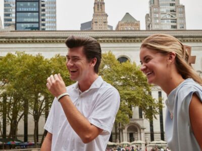 Two employees laughing together outside.
