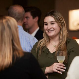 Person at Stavtar event talking with colleagues.